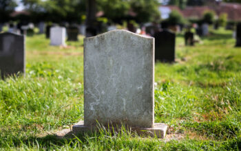 Blank gravestone surrounded by grass